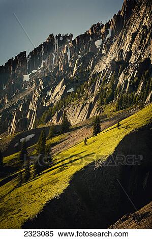 Warm grassy slopes and rocky crags of elpoca mountain; Kananaskis alberta canada View Large Photo Image Stock Photography - Warm grassy slopes and rocky crags of elpoca mountain; Kananaskis alberta canada. Fotosearch