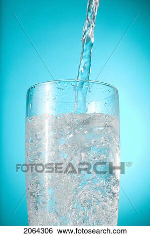 Stock Photograph - Water Pouring Into Nearly Full Glass. Fotosearch