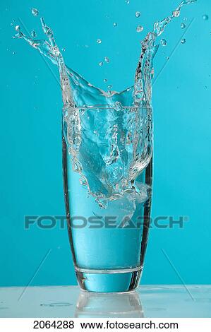 Water Splash As Ice Cube Drops Into Glass Of Water View Large Photo Image Stock Photo - Water Splash As Ice Cube Drops Into Glass Of Water. Fotosearch
