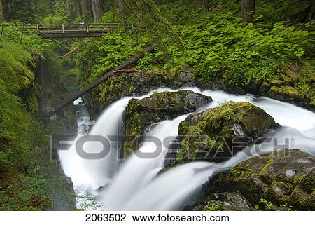 Stock Image - Waterfall Plunges Into A Canyon In An Old-Growth Rainforest; Usa, Washington, Olympic National Park, Sol Duc River. Fotosearch
