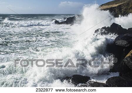 Waves breaking over the rocky shore of bolus head; Ballinskelligs ring of skelligs county kerry ireland View Large Photo Image Stock Photo - Waves breaking over the rocky shore of bolus head; Ballinskelligs ring of skelligs county kerry ireland. Fotosearch