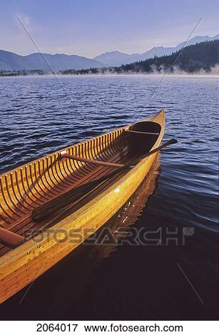 Stock Photo - Wood Canoe With Paddles On Alta Lake, Whistler, In Early Morning. Fotosearch