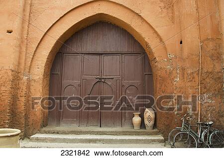 Wooden Door Of A House With An Archway And Two Bikes Parked Outside; Marrakech Morocco View Large Photo Image Stock Image - Wooden Door Of A House With An Archway And Two Bikes Parked Outside; Marrakech Morocco. Fotosearch