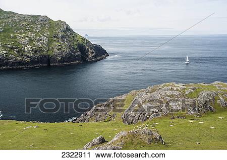 Stock Image - Yacht sailing into dursley sound; Beara peninsula county kerry ireland. Fotosearch