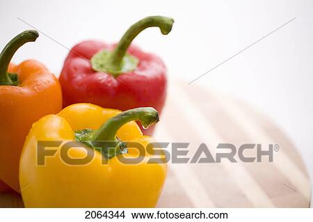 Yellow, Orange And Red Peppers On Butcher Block Cutting Board View Large Photo Image Picture - Yellow, Orange And Red Peppers On Butcher Block Cutting Board. Fotosearch