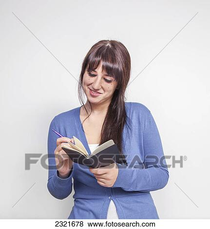 Young Woman Writing In Her Journal; Connecticut United States Of America View Large Photo Image Stock Photo - Young Woman Writing In Her Journal; Connecticut United States Of America. Fotosearch