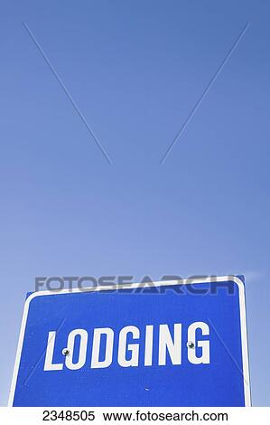 A blue sign for lodging against a blue sky; Canada View Large Photo Image Stock Photography - A blue sign for lodging against a blue sky; Canada. Fotosearch