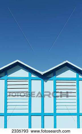 Stock Image - A blue wall with two peaks against a blue sky. Fotosearch