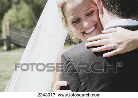 A bride and groom in an embrace; Pemberton, British Columbia, United States of America View Large Photo Image Stock Photo - A bride and groom in an embrace; Pemberton, British Columbia, United States of America. Fotosearch