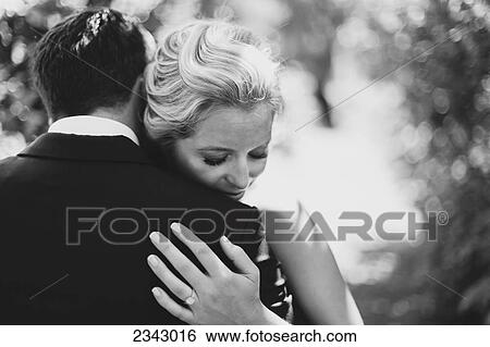 A bride and groom in an embrace; Pemberton, British Columbia, United States of America View Large Photo Image Stock Photograph - A bride and groom in an embrace; Pemberton, British Columbia, United States of America. Fotosearch