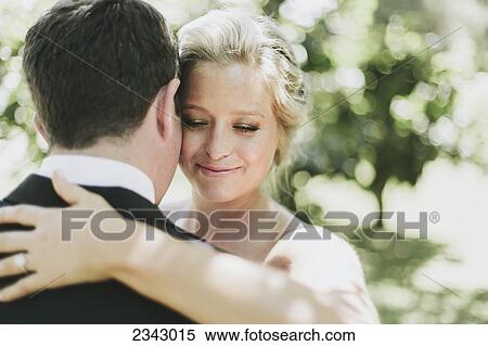 A bride and groom in an embrace; Pemberton, British Columbia, United States of America View Large Photo Image Stock Photography - A bride and groom in an embrace; Pemberton, British Columbia, United States of America. Fotosearch