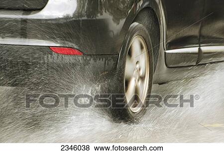 A car tire splashing through water; Locarno, Ticino, Switzerland View Large Photo Image Stock Photo - A car tire splashing through water; Locarno, Ticino, Switzerland. Fotosearch