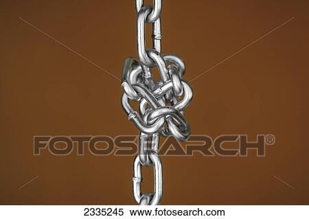 A chain tied in a knot against a brown background View Large Photo Image Stock Photography - A chain tied in a knot against a brown background. Fotosearch