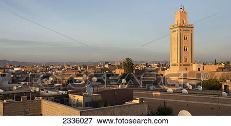 A city with satellite dishes on the roof of most buildings and a tower against a blue sky View Large Photo Image Stock Photo - A city with satellite dishes on the roof of most buildings and a tower against a blue sky. Fotosearch