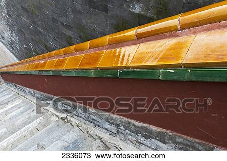 Stock Image - A colourful railing beside stone steps. Fotosearch