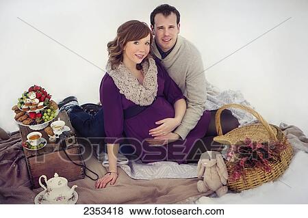 Stock Photo - A couple having a winter picnic during pregnancy; Edmonton, Alberta, Canada. Fotosearch