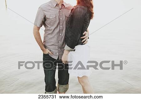 A couple standing in shallow water; Crescent Beach, British Columbia, Canada View Large Photo Image Stock Image - A couple standing in shallow water; Crescent Beach, British Columbia, Canada. Fotosearch