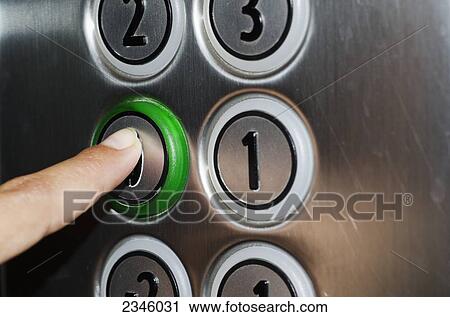 Stock Image - A finger pushing a button on an elevator; Locarno, Ticino, Switzerland. Fotosearch