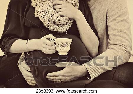 A husband embracing his pregnant wife's belly; Edmonton, Alberta, Canada View Large Photo Image Stock Image - A husband embracing his pregnant wife's belly; Edmonton, Alberta, Canada. Fotosearch