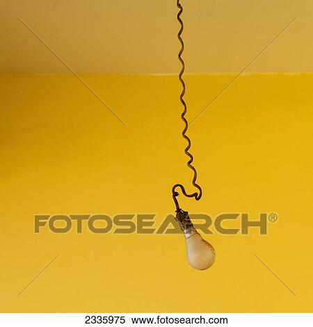 A lightbulb hanging on a spiral cord against a bright yellow background View Large Photo Image Stock Photography - A lightbulb hanging on a spiral cord against a bright yellow background. Fotosearch