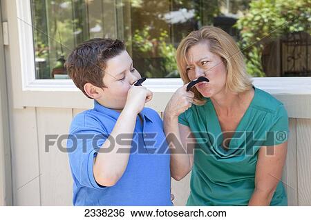 A mother and son hold moustaches up to their faces; Pacifica, California, United States of America View Large Photo Image Stock Photograph - A mother and son hold moustaches up to their faces; Pacifica, California, United States of America. Fotosearch
