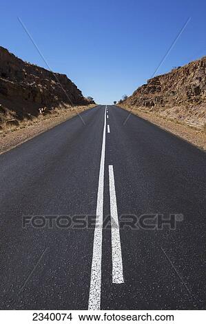 Picture - A road with a blue sky; Klein-Aus, Namibia. Fotosearch