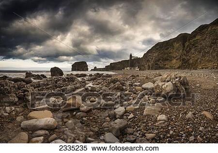 A rocky beach along the water's edge; South Shields, Tyne and Wear, England View Large Photo Image Stock Photography - A rocky beach along the water's edge; South Shields, Tyne and Wear, England. Fotosearch