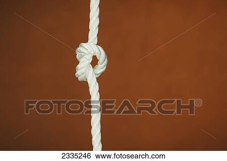 A rope tied in a knot against a brown background View Large Photo Image Stock Photograph - A rope tied in a knot against a brown background. Fotosearch