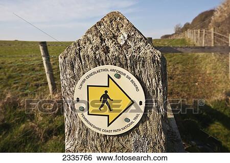 Stock Photograph - A sign for a walking trail in the Pembrokeshire Coast Path National Trail; Wales. Fotosearch