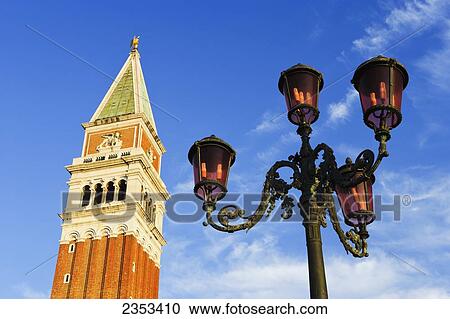 Stock Image - A tower and lamp post in Piazza San Marco; Venice, Italy. Fotosearch