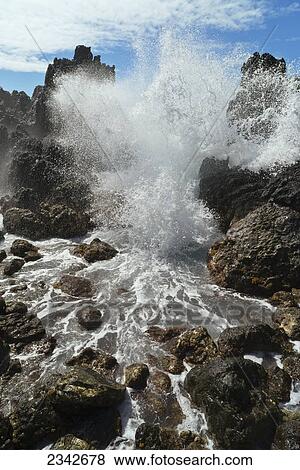 Stock Photo - A wave crashing and splashing against rocks; Lapahoehoe, Hamakua, Big Island, Hawaii, United States of America. Fotosearch