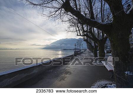 A wet path and traces of snow along the water's edge View Large Photo Image Stock Image - A wet path and traces of snow along the water's edge. Fotosearch
