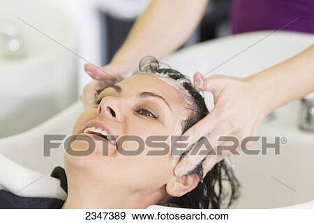 A woman getting her hair washed in a salon sink; Locarno, Ticino, Switzerland View Large Photo Image Stock Photo - A woman getting her hair washed in a salon sink; Locarno, Ticino, Switzerland. Fotosearch