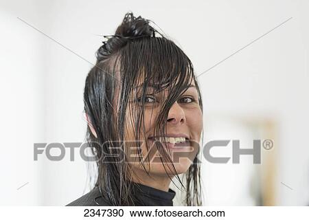 Stock Image - A woman with wet hair ready for a haircut; Locarno, Ticino, Switzerland. Fotosearch