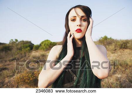 A young woman with black and green long hair posing in an outdoor environment; California, United States of America View Large Photo Image Stock Image - A young woman with black and green long hair posing in an outdoor environment; California, United States of America. Fotosearch