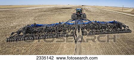 An air seeder and tractor in a field with blue sky; Alberta, Canada View Large Photo Image Stock Image - An air seeder and tractor in a field with blue sky; Alberta, Canada. Fotosearch