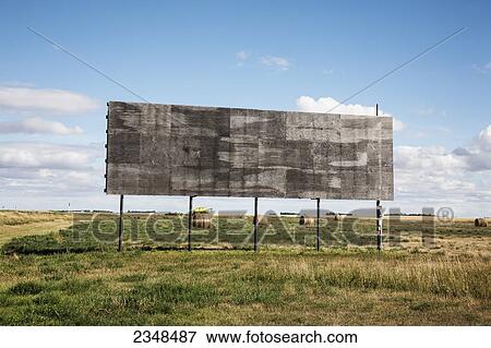 Stock Photo - An empty billboard beside a farm field; Alberta, Canada. Fotosearch