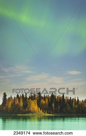 Picture - Autumn foliage reflected in the water at the Chena Lakes Recreation area, Northern Lights in the sky; Fairbanks, Alaska, United States of America. Fotosearch