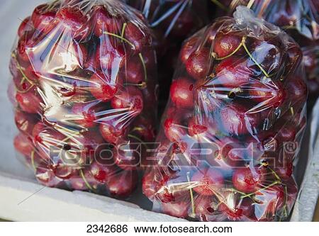 Stock Photograph - Bags of cherries; Oahu, Hawaii, United States of America. Fotosearch