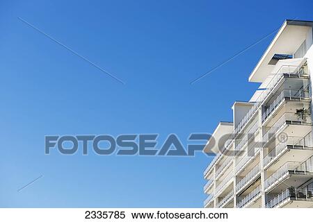 Stock Photography - Balconies on a building against a blue sky. Fotosearch