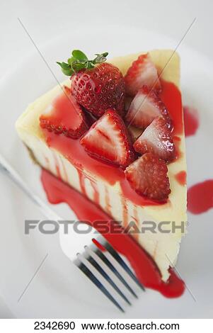 Stock Image - Cheesecake topped with strawberries; Oahu, Hawaii, United States of America. Fotosearch