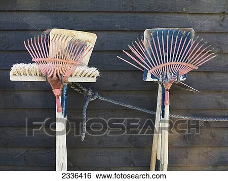 Cleaning tools hanging on a wooden wall; Spain View Large Photo Image Stock Photograph - Cleaning tools hanging on a wooden wall; Spain. Fotosearch