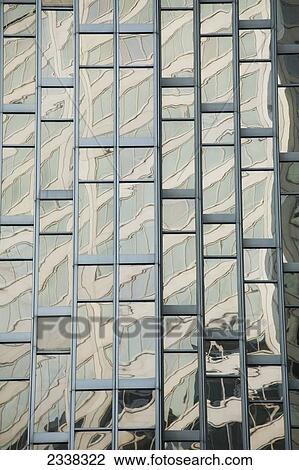 Stock Image - Close up of a gold glass building reflecting another building; Toronto, Ontario, Canada. Fotosearch
