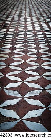Stock Image - Close up of a patterned tile floor; India. Fotosearch