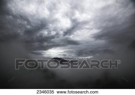 Stock Photography - Clouds above the Swiss Alps; Locarno, Ticino, Switzerland. Fotosearch