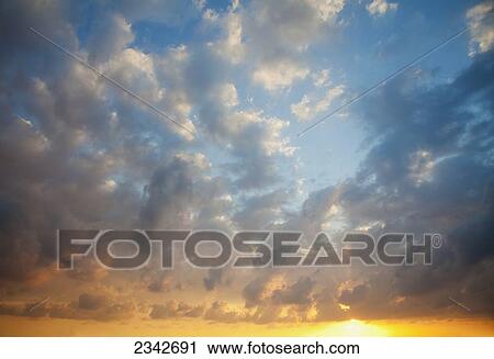 Clouds in the sky with the golden horizon glowing at sunset; Oahu, Hawaii, United States of America View Large Photo Image Stock Image - Clouds in the sky with the golden horizon glowing at sunset; Oahu, Hawaii, United States of America. Fotosearch