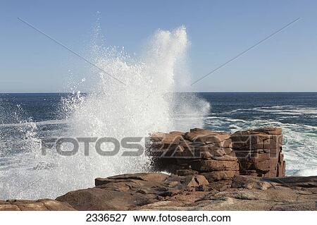 Stock Photo - Crashing waves on the rocky coast of the Atlantic ocean in Acadia National Park; Maine, United States of America . Fotosearch