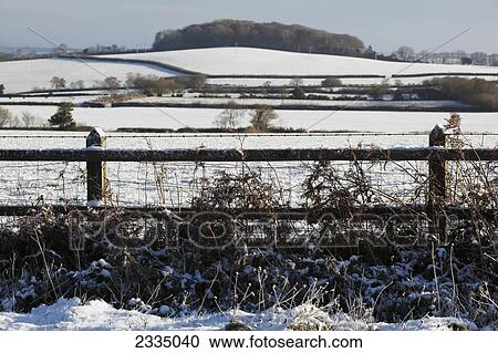 Stock Image - Fields covered in snow in winter; North Devon, England. Fotosearch