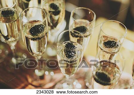 Glasses of champagne in a row; Pemberton, British Columbia, Canada View Large Photo Image Stock Photo - Glasses of champagne in a row; Pemberton, British Columbia, Canada. Fotosearch