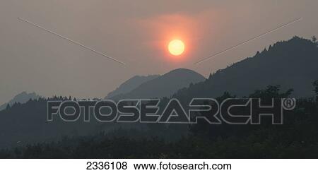 Glowing sunlight over the mountainous landscape; Beijing, China View Large Photo Image Stock Photo - Glowing sunlight over the mountainous landscape; Beijing, China. Fotosearch